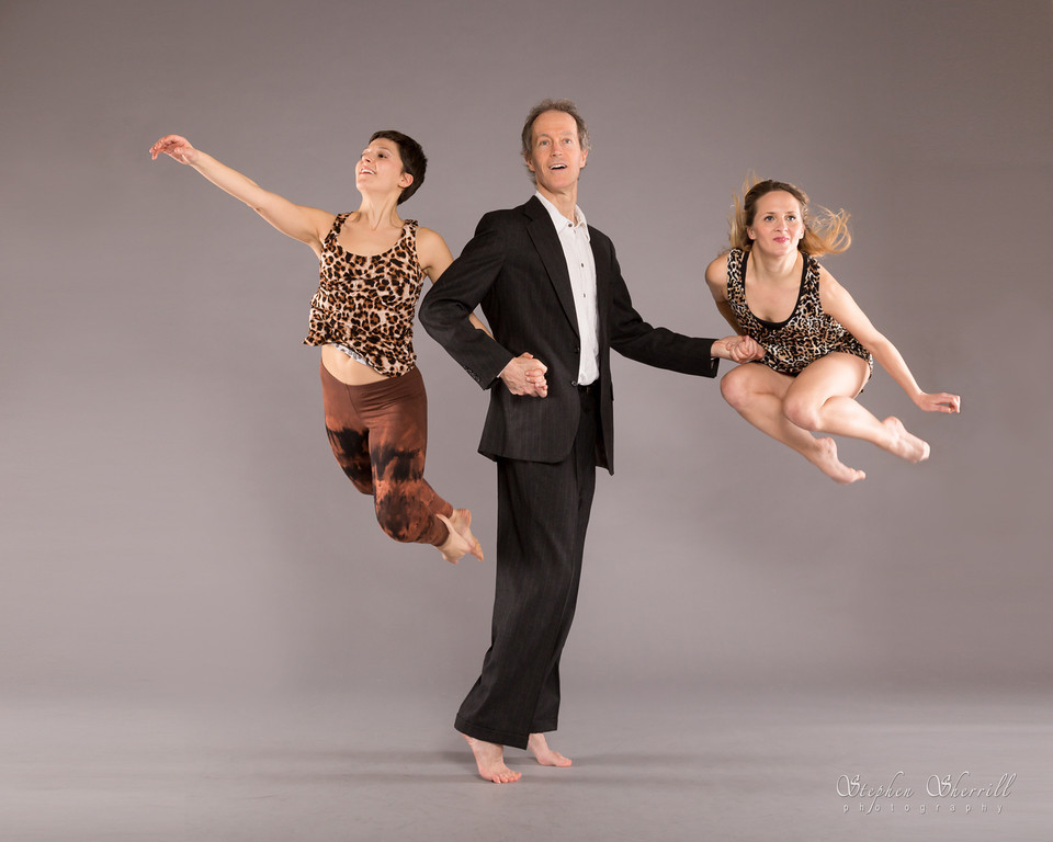 Stephen Kelley, Co-Director and Co-Founder, flanked by dancers in flight